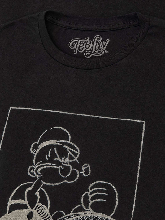 Black T-shirt close-up of “Salty” sailor graphic print