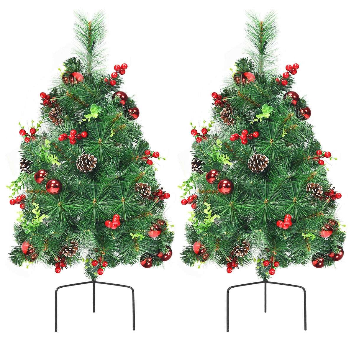 Pair of decorated Christmas trees with red berries, ornaments, pine cones, and metal stands