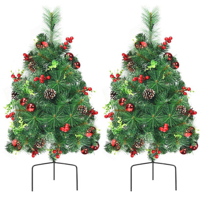 Pair of decorated Christmas trees with red berries, ornaments, pine cones, and metal stands