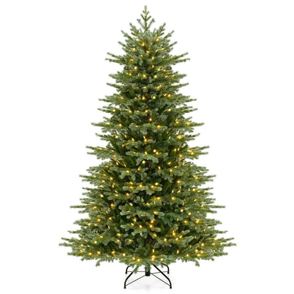 Lit artificial Christmas tree with a narrow profile and black metal stand