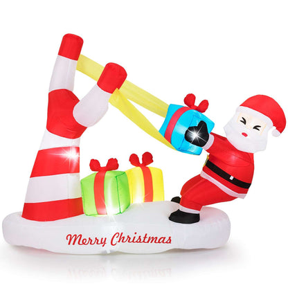 Inflatable Santa slingshot decoration with red and white bands, gifts, and LED lights