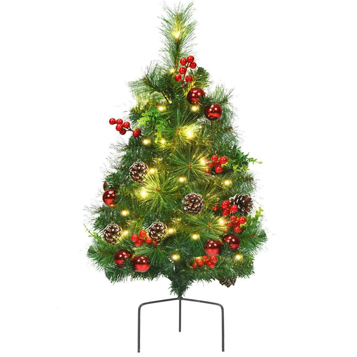 Single pre-lit Christmas tree decorated with red berries, red ornaments, and pine cones