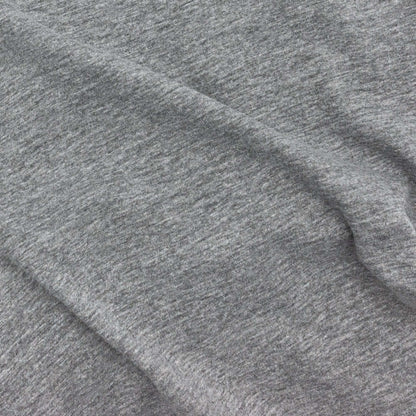 Gray heather cotton T-shirt fabric texture with side seam visible