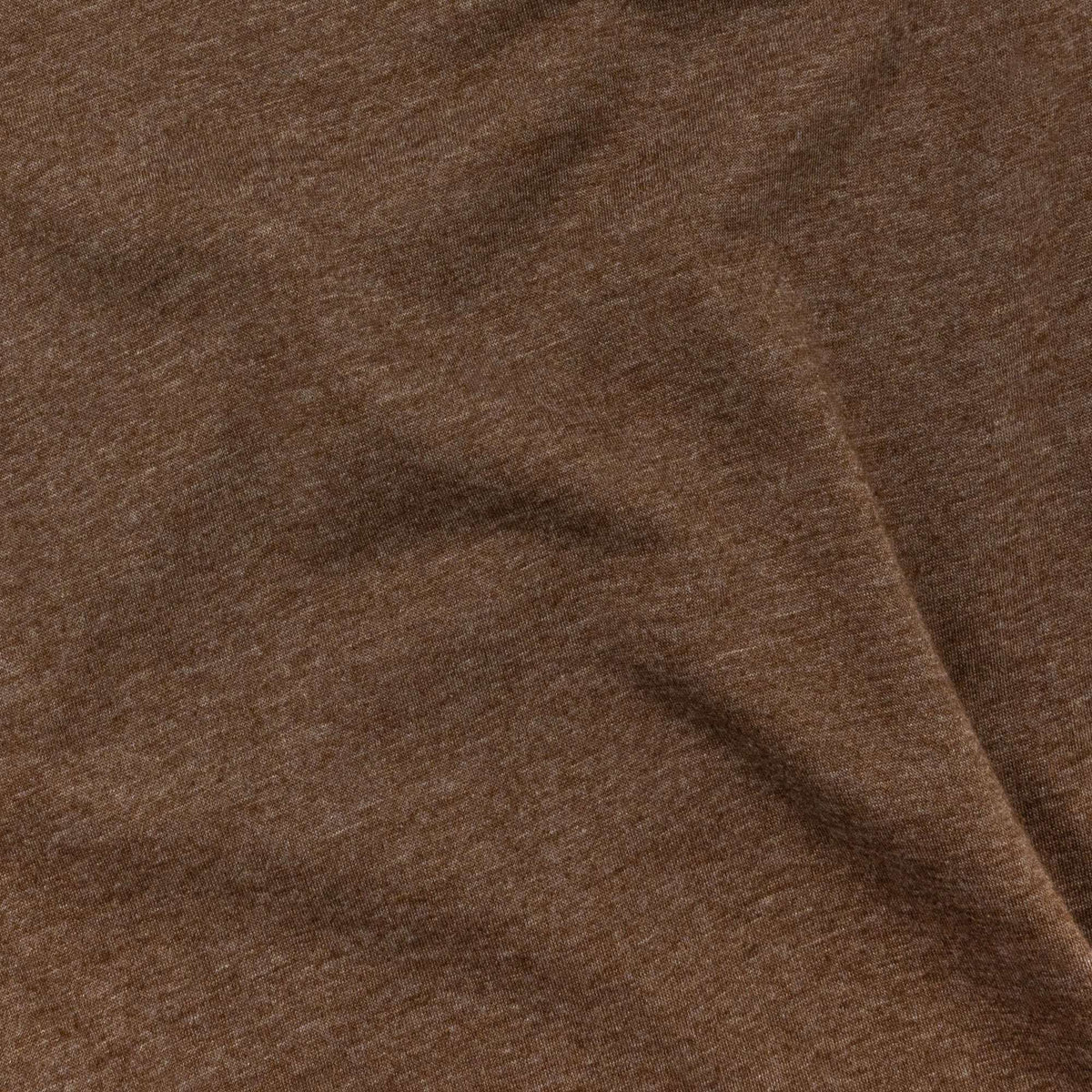 Brown T-shirt fabric texture close-up with fine knit pattern