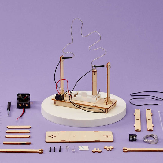 Buzz wire game kit with wooden base, upright posts, and looping wire challenge