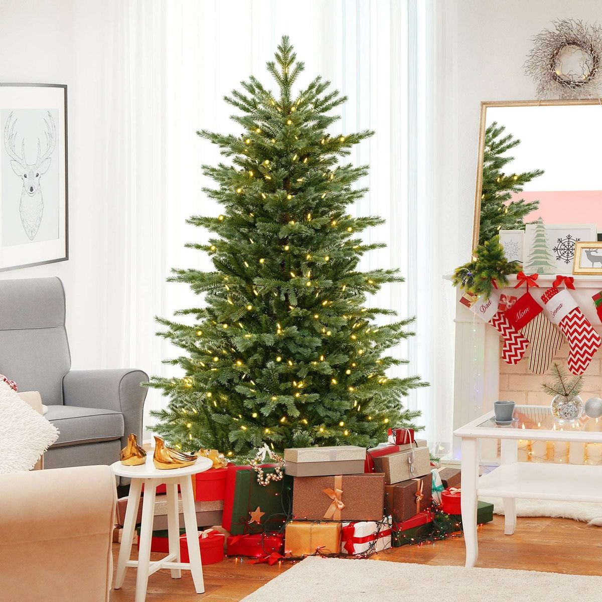 Artificial Christmas tree with warm white lights displayed with holiday gifts