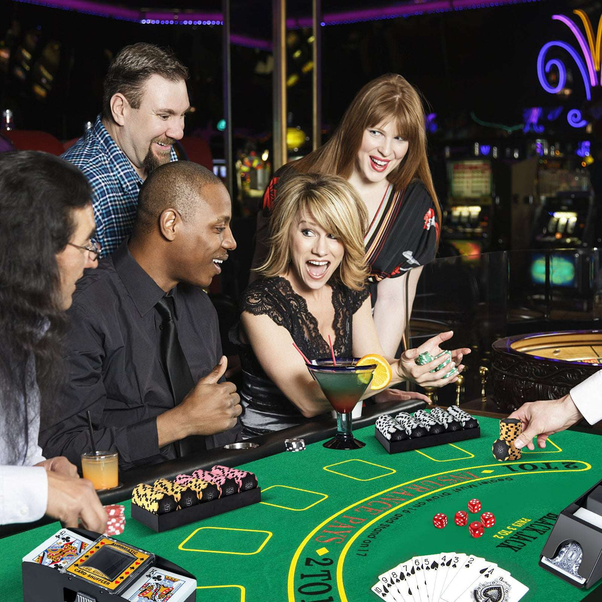 Poker chip set with black and multicolor chips on green felt table and cards