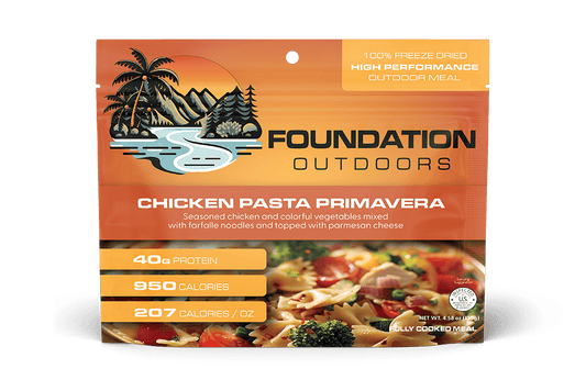 Freeze-dried chicken pasta primavera meal pouch, orange packaging with outdoor branding.