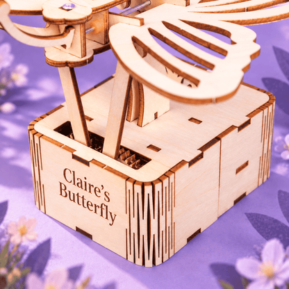Wooden butterfly kit side view showing inner wing mechanism inside the box