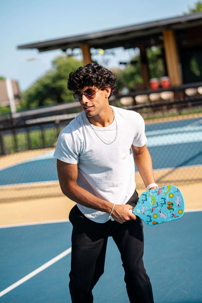 Blue pickleball paddle with colorful speckled grip and textured face