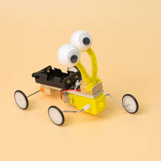 Bug robot DIY kit: yellow wheeled build with googly eyes, black body, wire feelers
