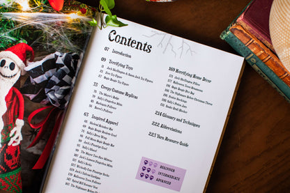 Knitting guide open to its contents page, with a knitted Jack Skellington beside it
