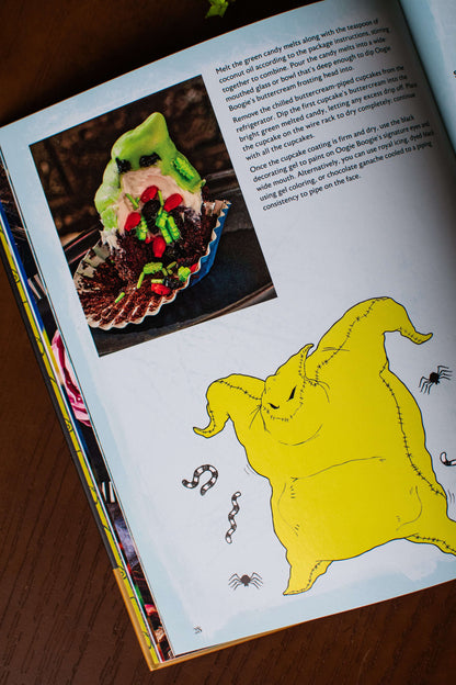 Open cookbook page with a monster dessert photo and yellow character illustration