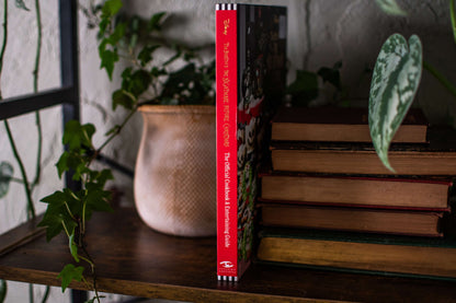 The Nightmare Before Christmas cookbook shown spine-out, with a red spine and hardcover binding
