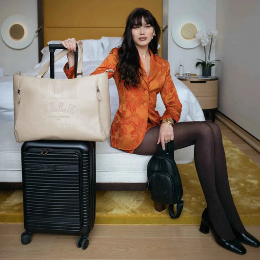 Black luggage set with wheeled suitcase, duffel bag, and small crossbody bag