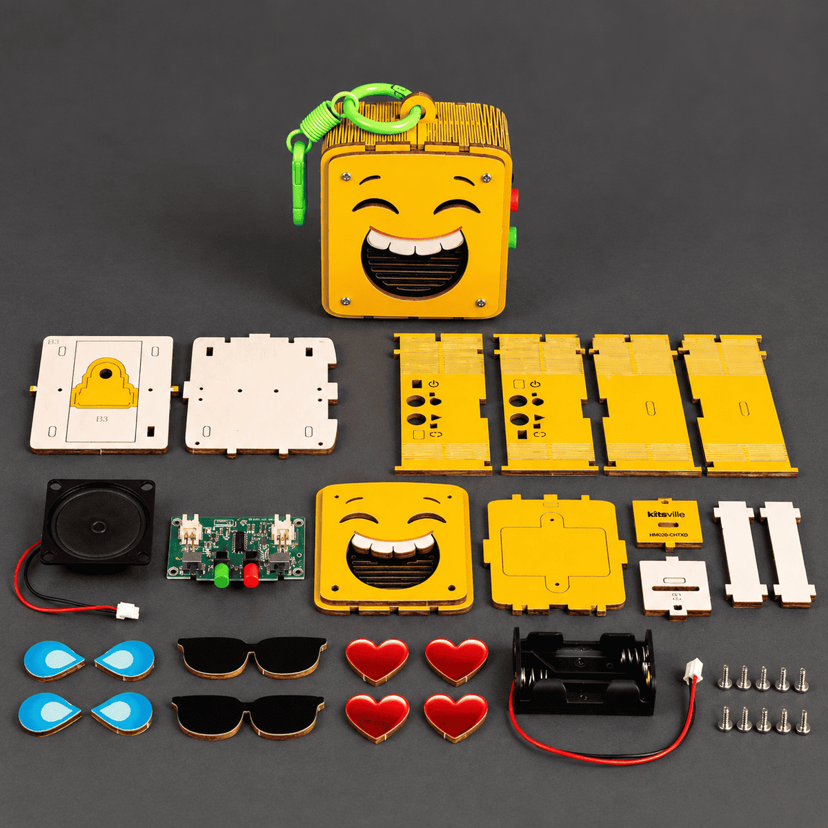 DIY emoji voice recorder kit parts with yellow face module, screen pieces, buttons, wiring