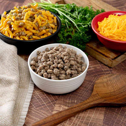 Freeze-dried meat crumbles in a white bowl with meal sides