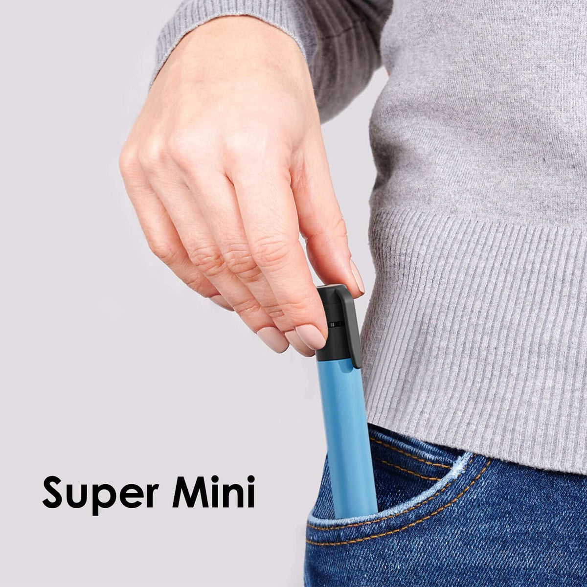 Super mini water purification straw held in hand, light blue body with black flip cap