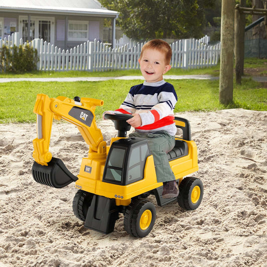 Yellow kids ride-on excavator with black bucket and cab, on sandy ground
