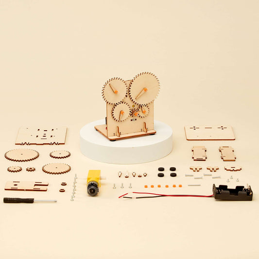Mechanical gear kit parts laid out: gears, panels, screws, rods, motor block