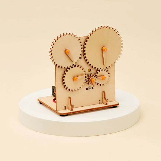 Wooden gear train DIY kit with interlocking gears and orange pegs on base