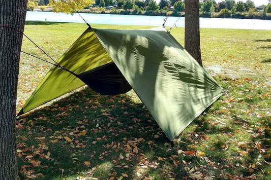 Green hammock rain fly, angled coverage with support lines and side panel