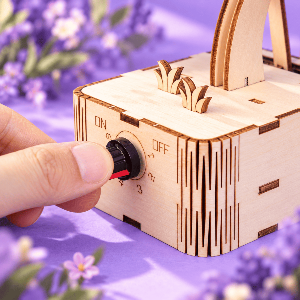 Wooden butterfly kit close-up with hand turning the side control knob