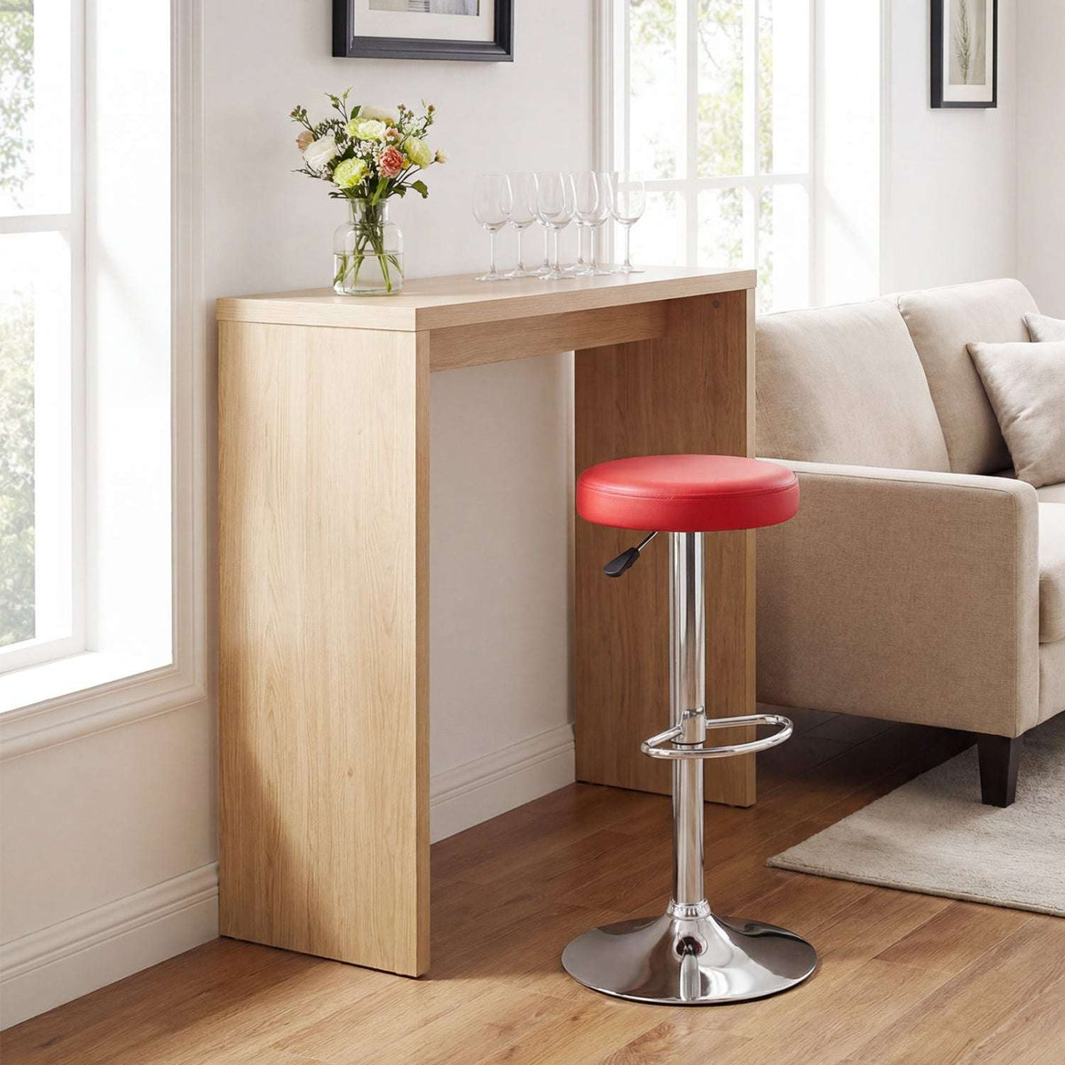 Red adjustable swivel bar stool with padded seat, chrome pedestal, footrest and round base