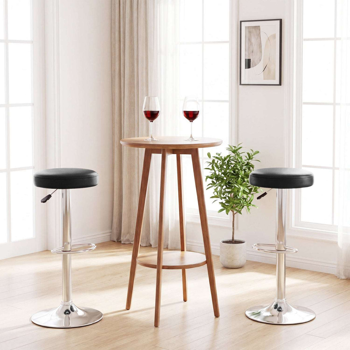 Two black adjustable swivel bar stools with padded seats, chrome pedestals and round bases