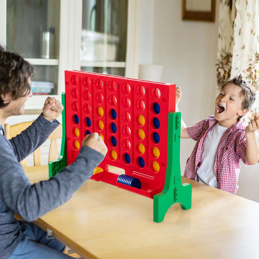 Jumbo connect-four board game with red frame, green legs, colored pegs and stand
