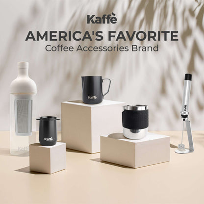Kaffe stainless steel milk frothing pitcher with black silicone sleeve on countertop