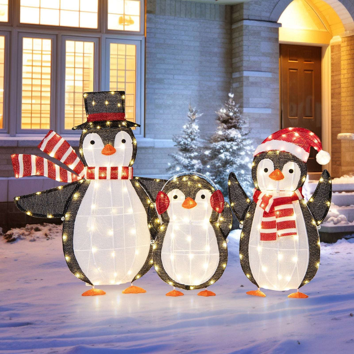 Three LED penguin decorations with warm white lights, red accents and different festive accessories