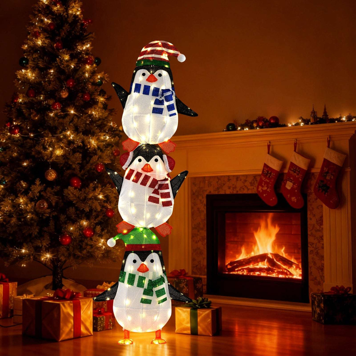 Three stacked penguin decoration illuminated by warm white LED lights.