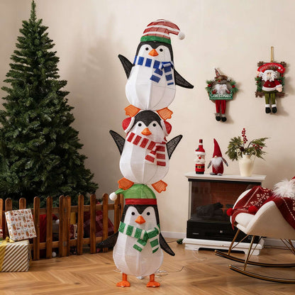 Three stacked fabric penguins with colorful scarves and hats, shown unlit.