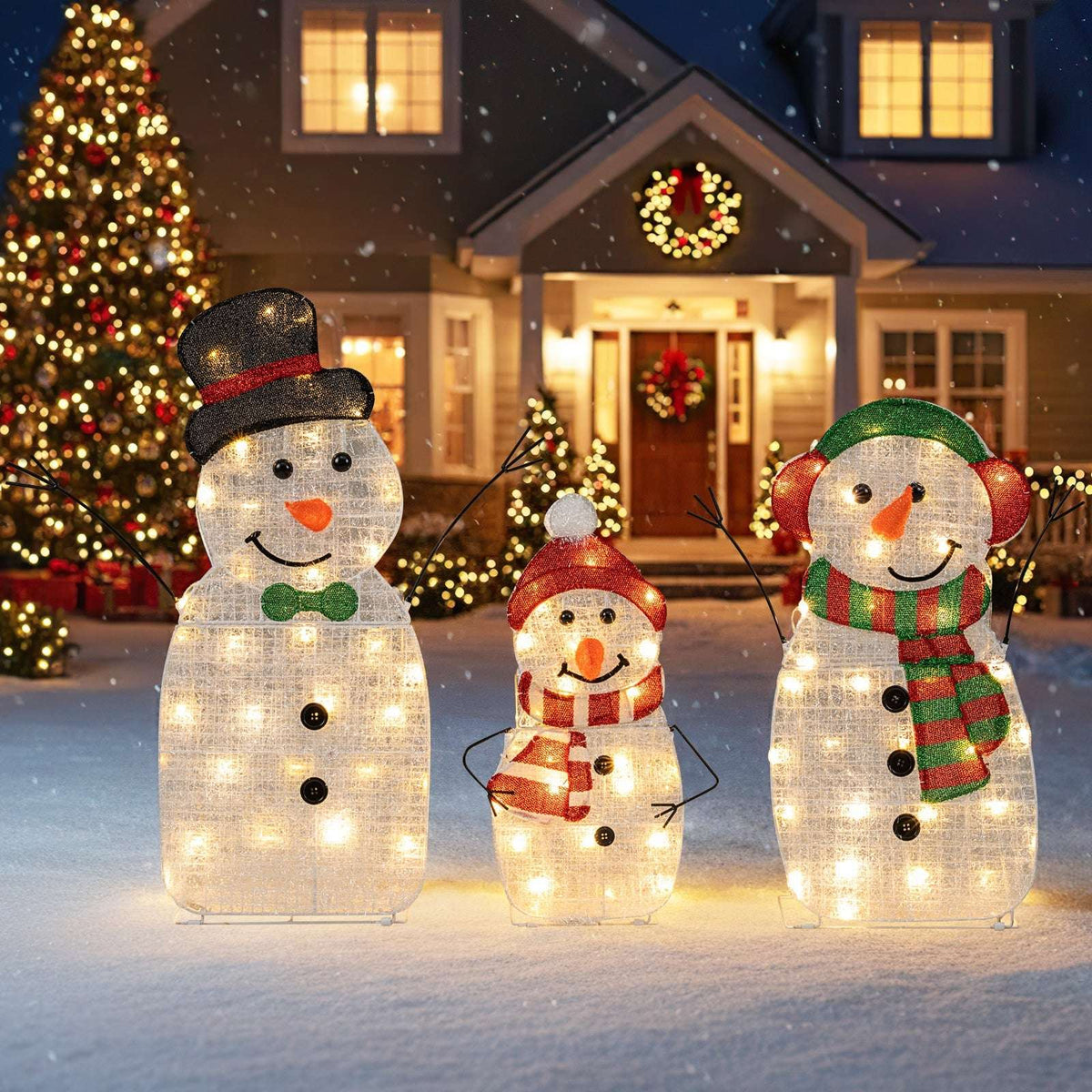 Three-piece lighted snowman family decoration with hats, scarves, carrot noses and warm white lights
