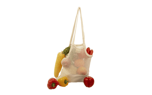 Organic cotton mesh tote bag holding mixed peppers and tomatoes, red and green.