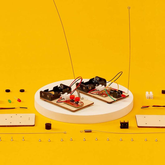 Telegraph and Morse code DIY electronics kit with two circuit boards and wiring on a stand