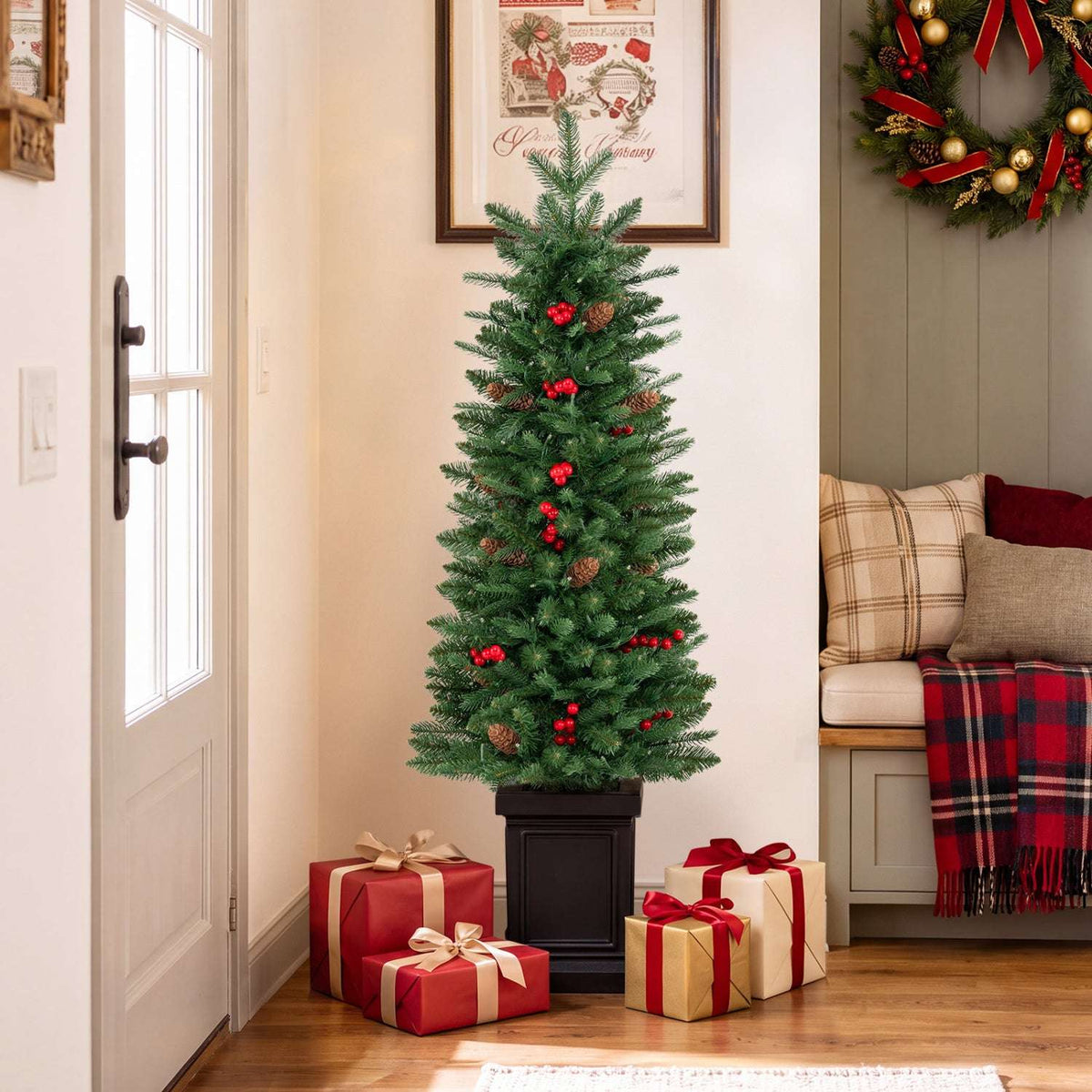 Potted Christmas tree with red berry accents in a black planter, unlit