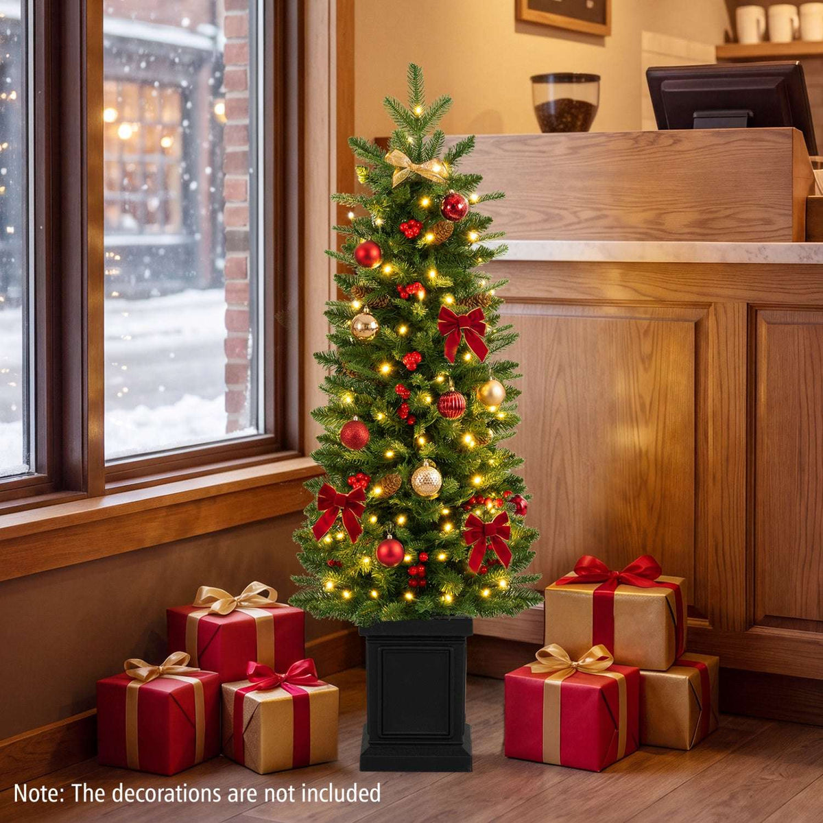 Slim pre-lit potted Christmas tree decorated with red and gold ornaments and bows