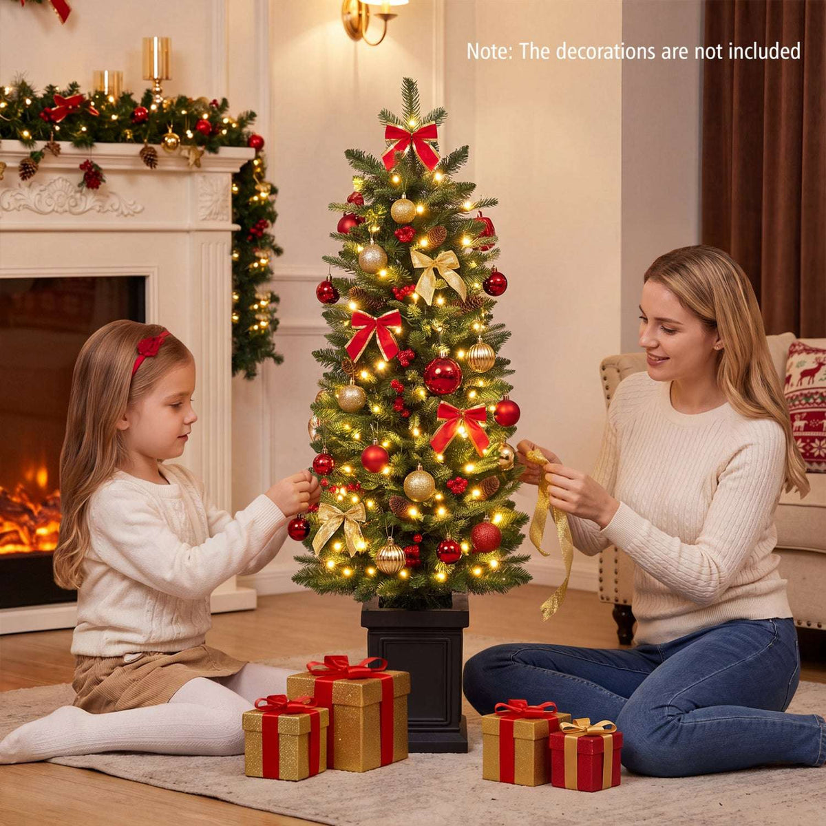 Pre-lit potted Christmas tree with warm white lights and red and gold decorations