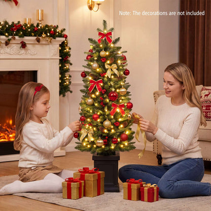 Pre-lit potted Christmas tree with warm white lights and red and gold decorations