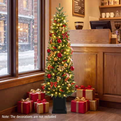 Pre-lit potted Christmas tree decorated with warm white lights, red and gold ornaments, and bows