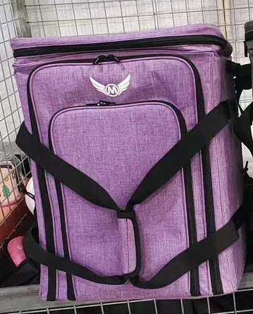 Purple padded board game carrying bag with front logo and crisscross shoulder straps