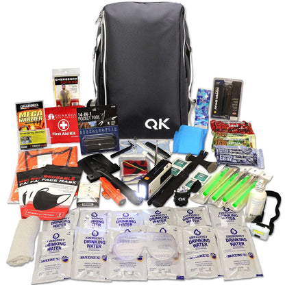 Black survival backpack kit with emergency supplies and tools laid out