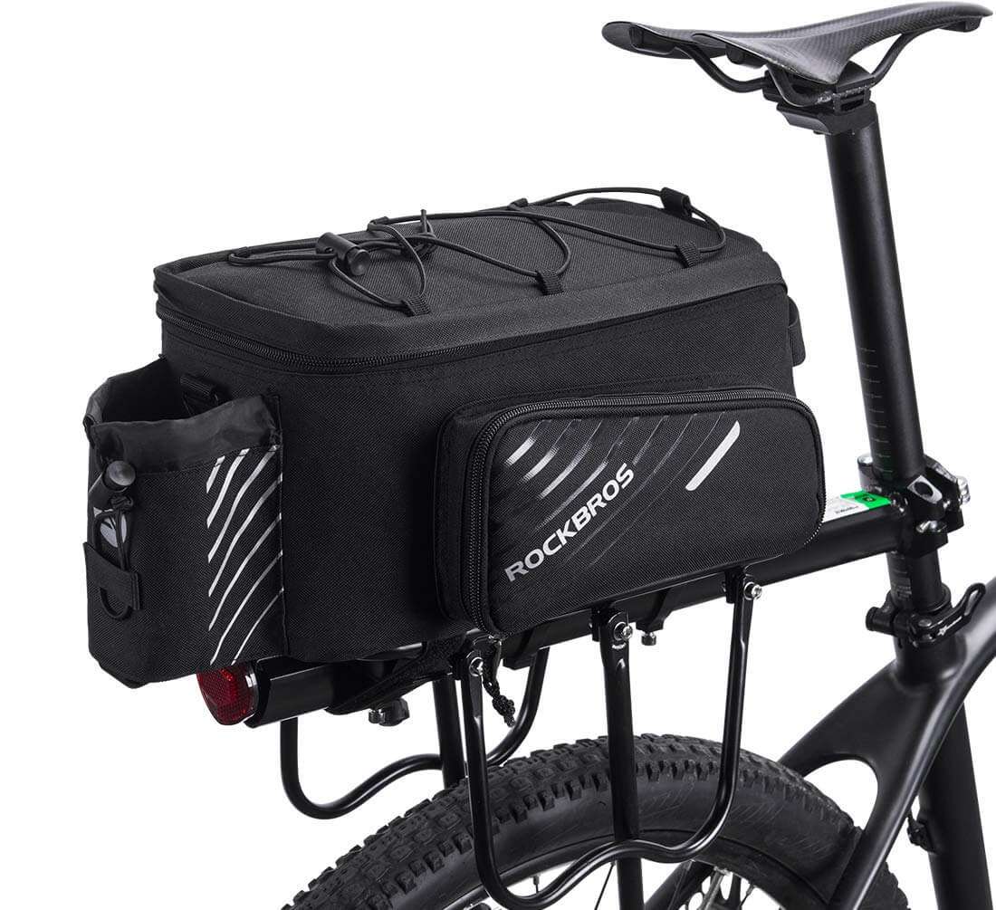 Black bike rack bag with ROCKBROS logo, front zip pocket, and top carry straps