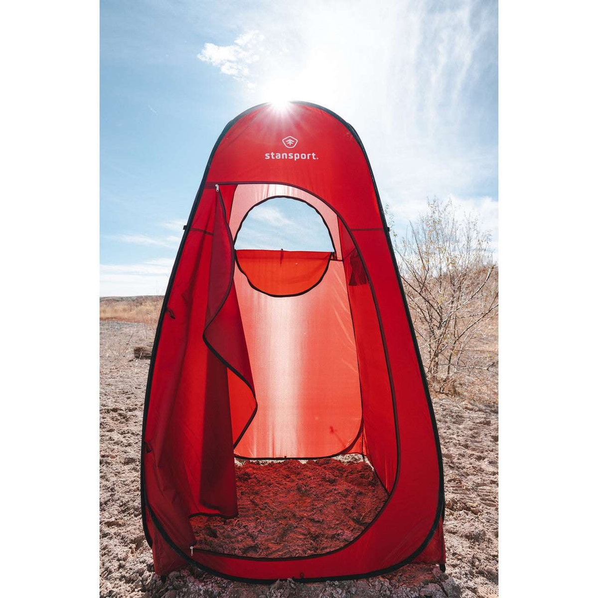 Red privacy tent with front mesh window opening and enclosed interior curtains