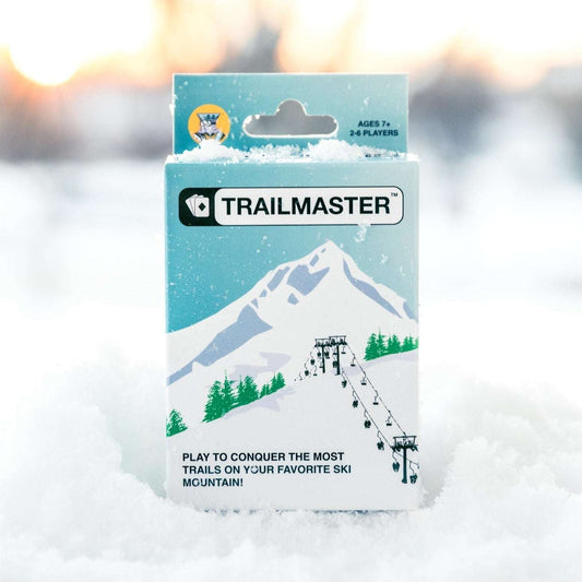 Trailmaster ski card game box with mountain graphics and game age info