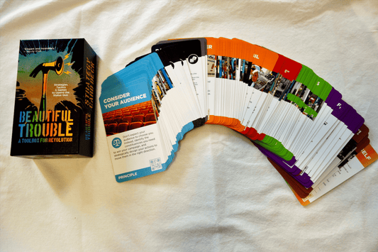 Strategy card deck with colorful rule cards fanned and matching box