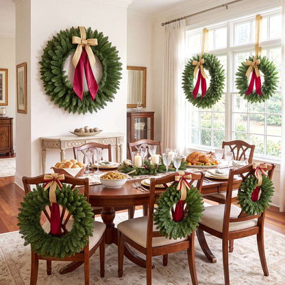 Green artificial Christmas wreaths decorated with gold bows and red ribbon tails