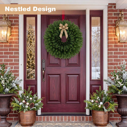 Large, full green artificial Christmas wreath with a gold bow